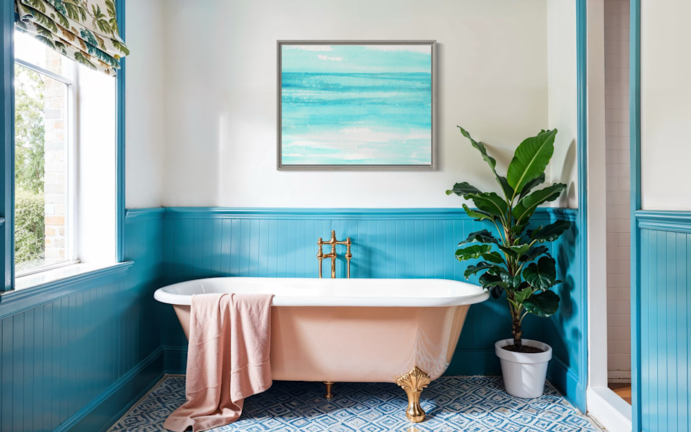 Coastal-inspired bathroom with teal walls and pink clawfoot tub, featuring a framed abstract art print and lush green plant.