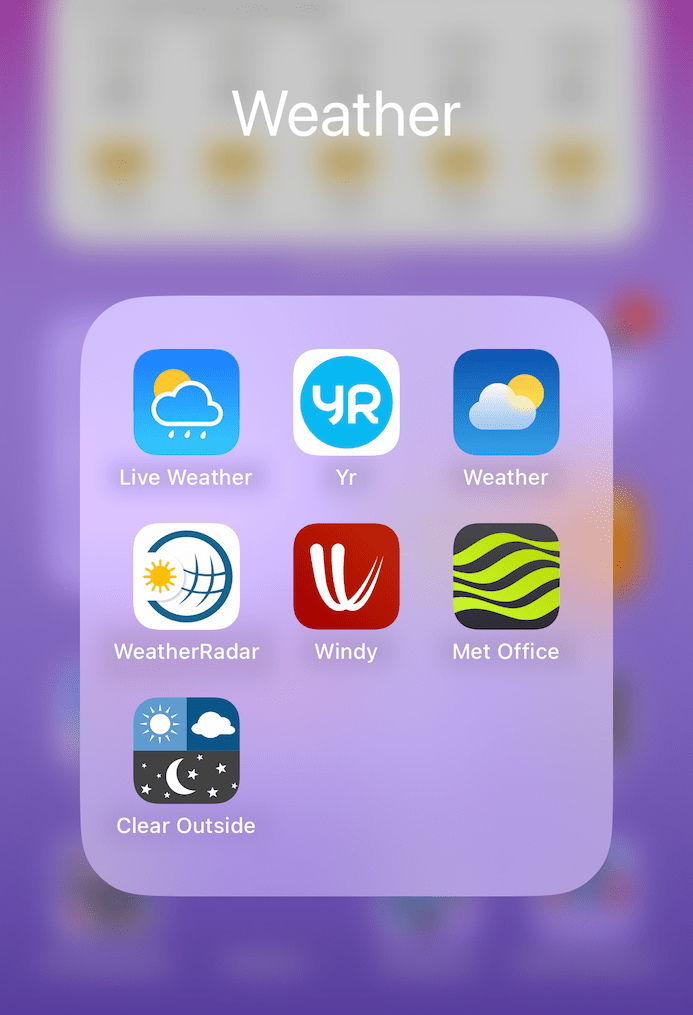 A phone screen showing a folder labelled Weather, with app icons for Live Weather, Yr, WeatherRadar, Windy, Met Office, and Clear Outside.