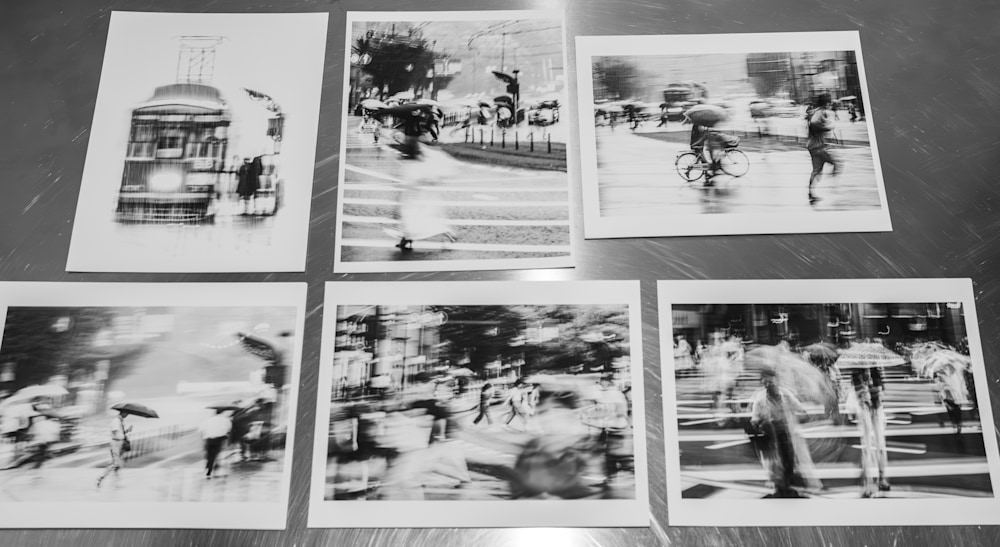 Overhead view of six Kumamoto Rain Study fine art prints arranged on a metal tabletop, showing texture, borders, and tonal consistency during the proofing process.