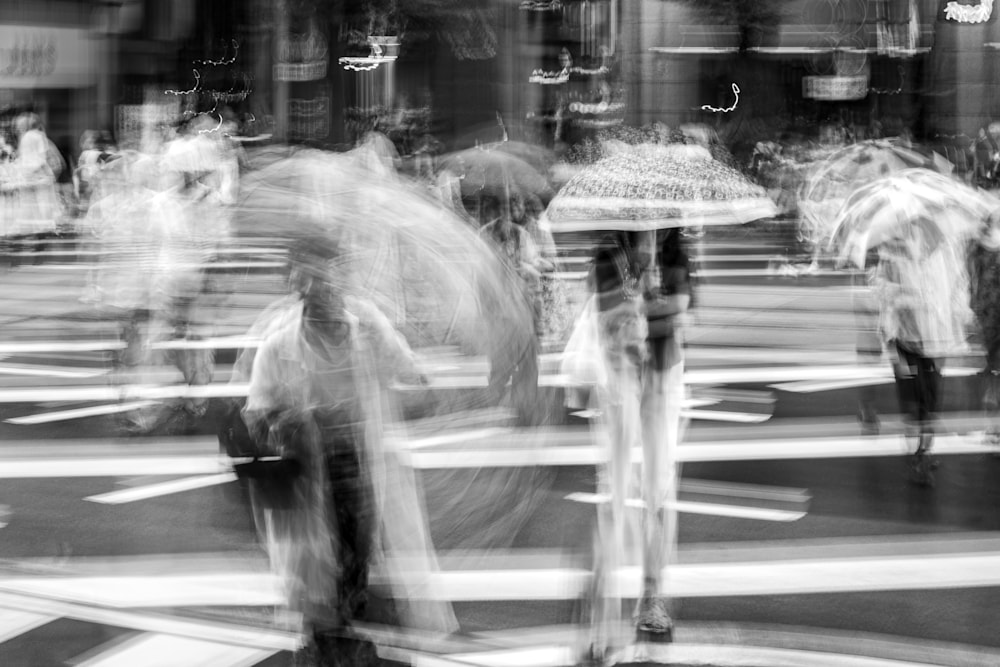 Woman rushing through intense rain as her umbrella blurs into a pinwheel shape from long-exposure motion.