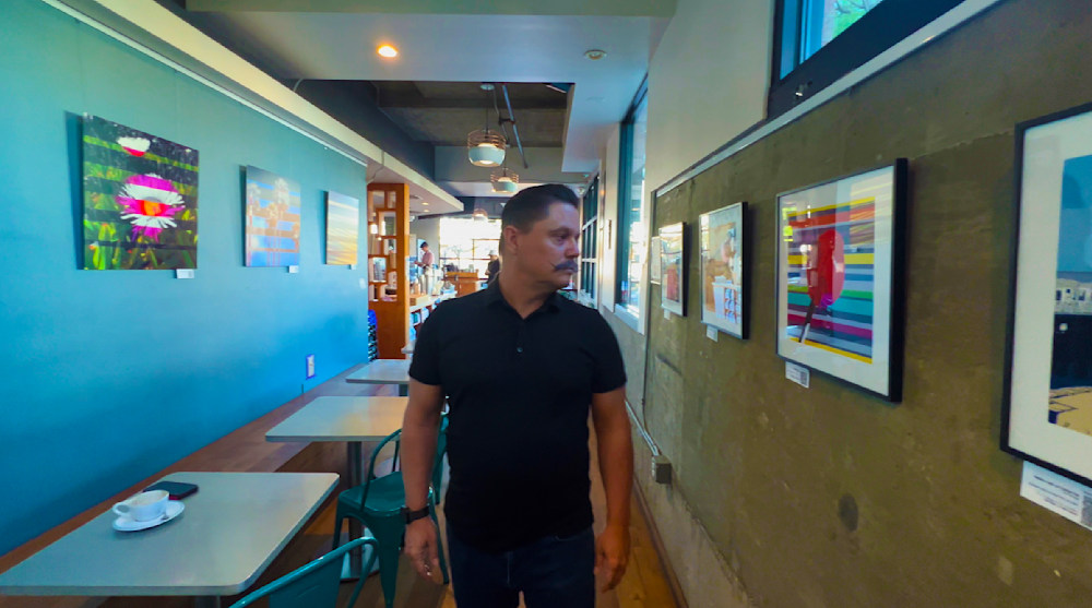 curated exhibition of ten original metal artworks and fine art prints by Jon Savage on display at Bird Rock Coffee Roasters.