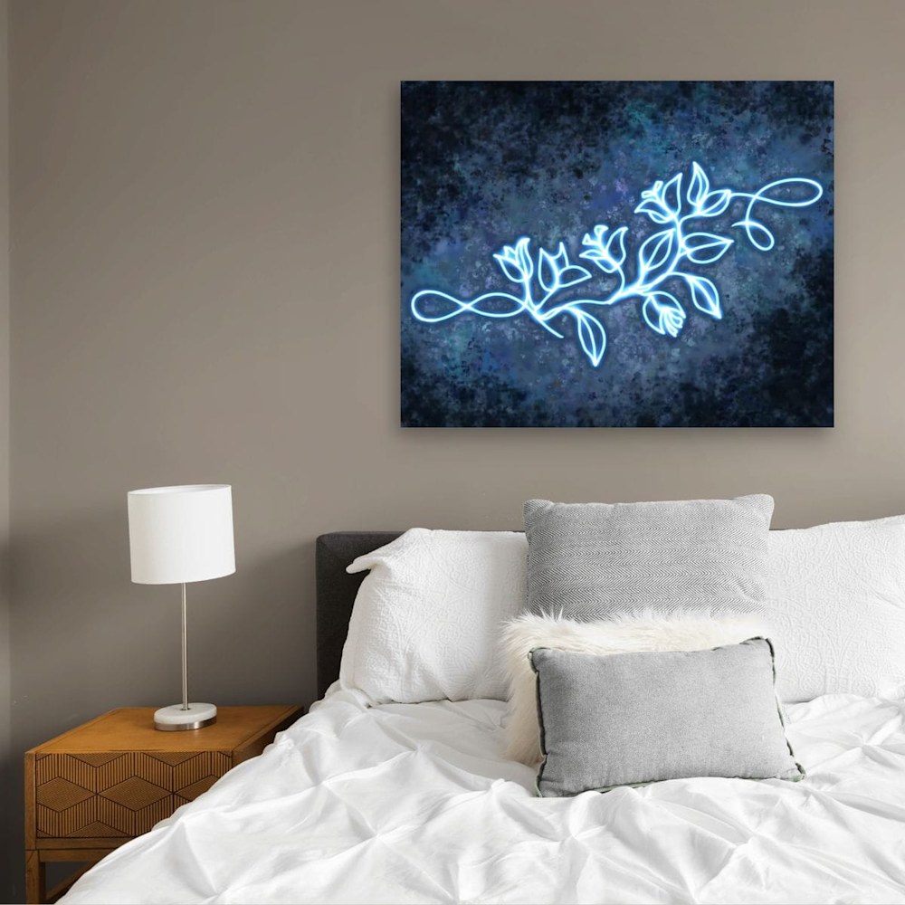 A glowing bougainvillea desert painting minimalist line art by Arizona artist Kristin Dragos shown above a bed.