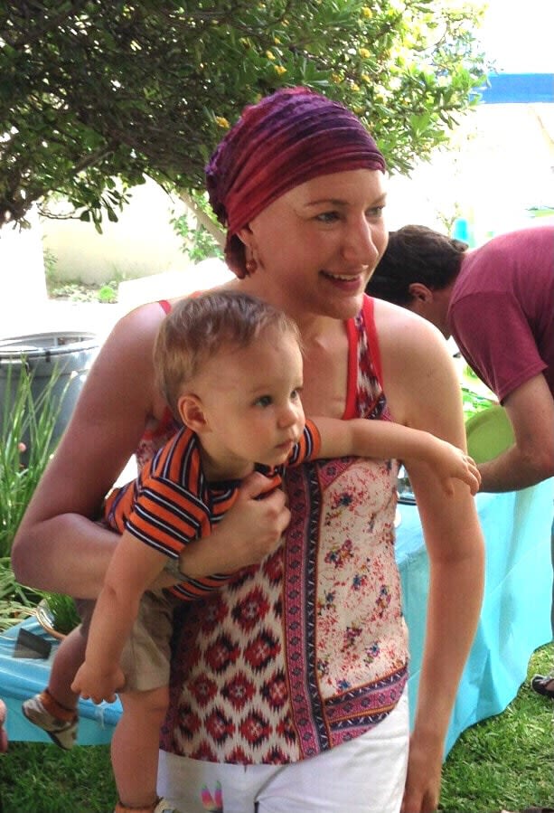 The Artist Wearing a head scarf when she had breast cancer, holding a 1-year old baby boy