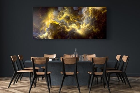 A metal print hanging over table.