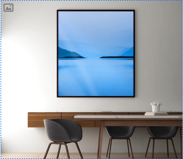 A framed metal print hanging above a table.