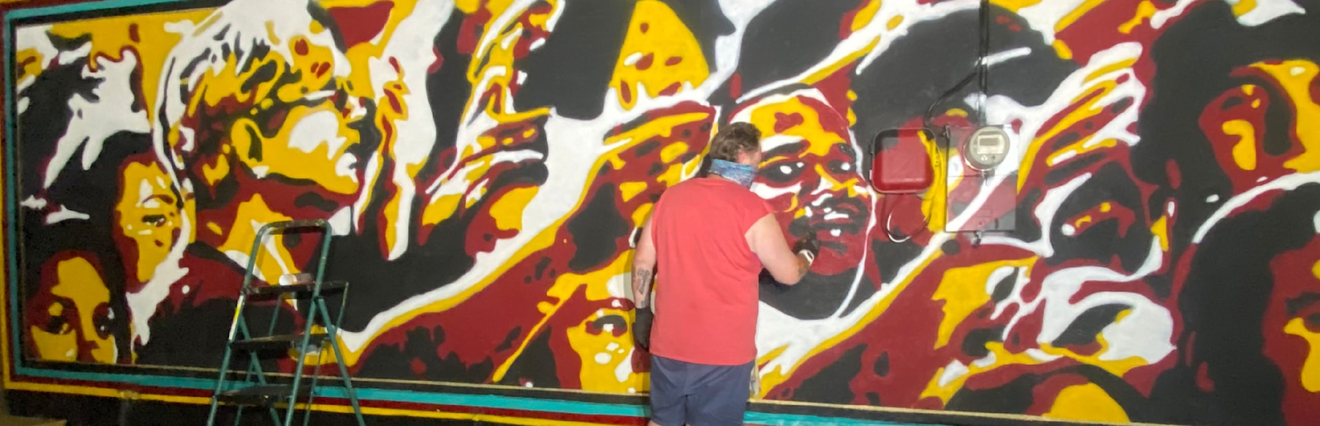 
        <div class='title'>
          briteso paints a Seminoles mural at the Garnet and Gold Store
        </div>
       
        <div class='description'>
          an artist paints on a wall using garnet, gold, black and white
        </div>
      