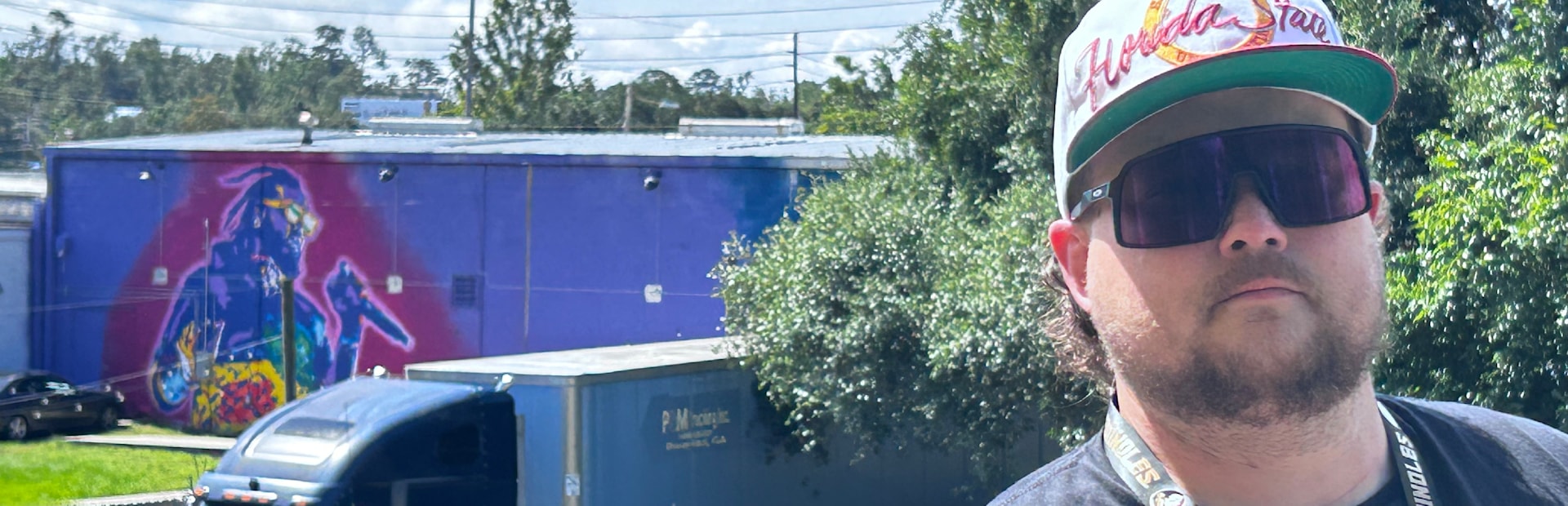 
        <div class='title'>
          The artist, briteso stands in front of his T Pain mural, "Tallahassee Love"
        </div>
       
        <div class='description'>
          An image of artist, briteso in Tallahassee, FL
        </div>
      