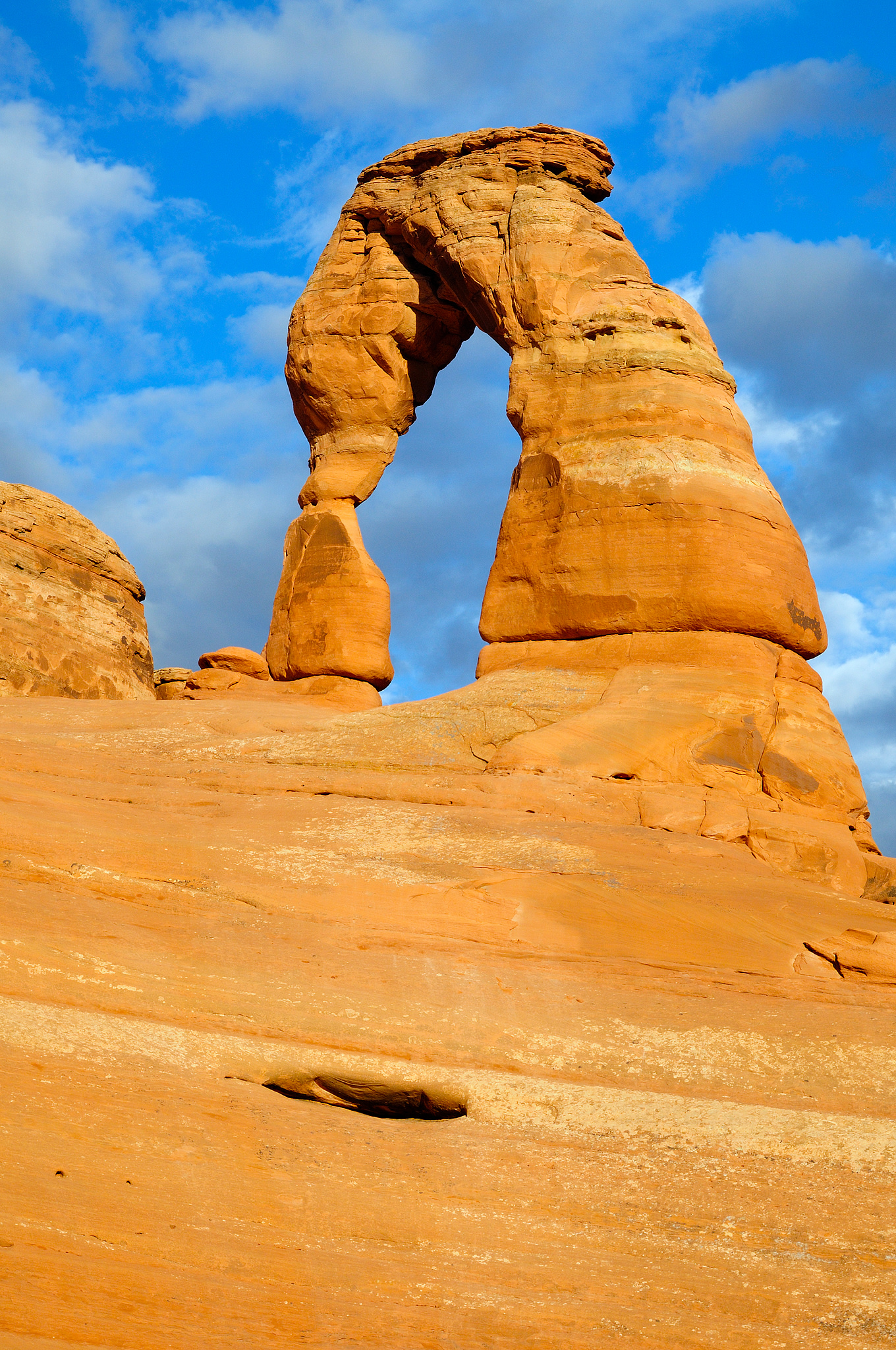 
        <div class='title'>
          Delicate Arch
        </div>
       
        <div class='description'>
          Delicate Arch is bathed in afternoon sun from this view in the bowl below the arch in Arches National Park
        </div>
      