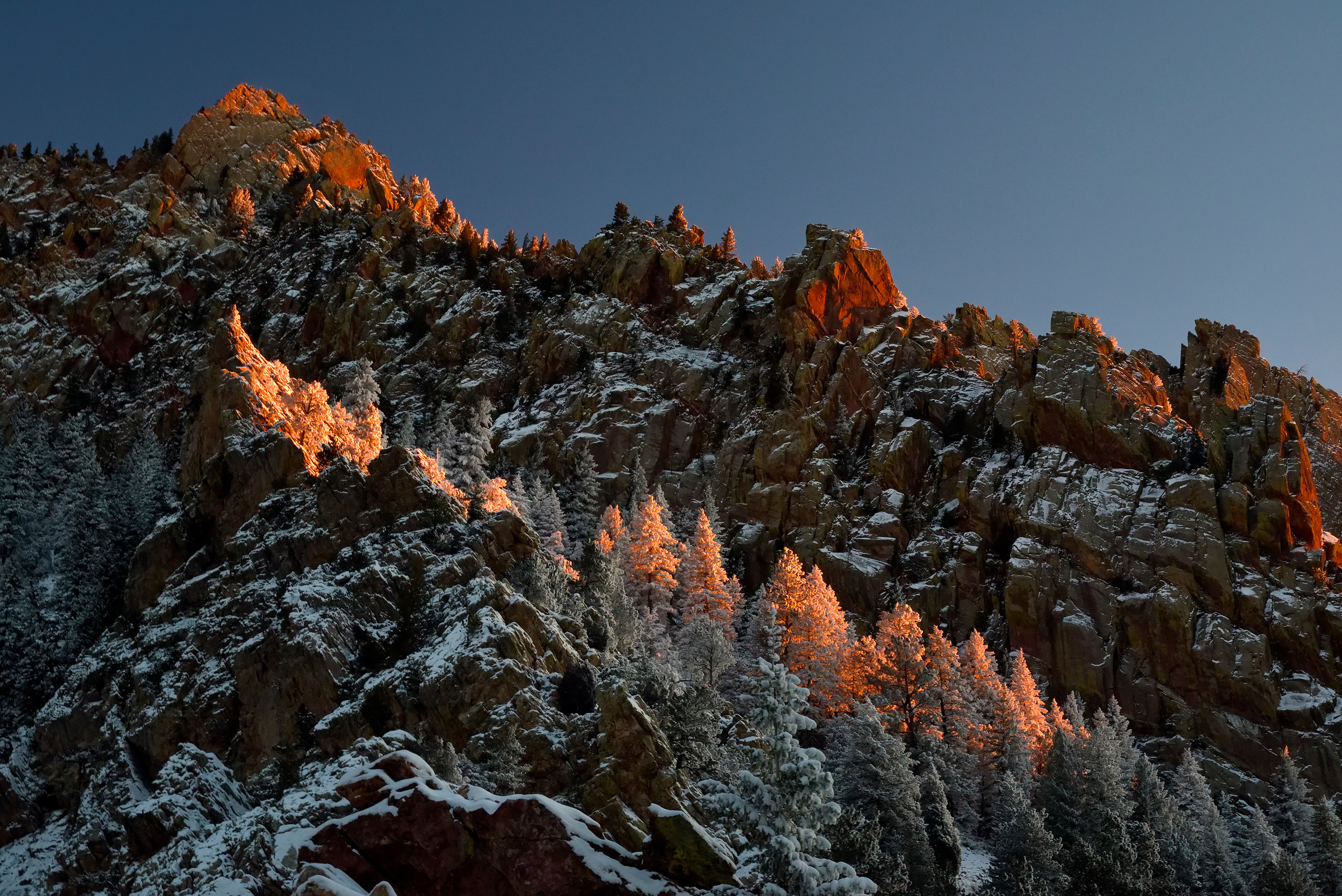 
        <div class='title'>
          Eldorado Dawn
        </div>
       
        <div class='description'>
          The first light of the morning casts a warm glow high on the walls of Eldorado Canyon, the morning after a frest winter snow. The contrast of warm sunlight and cool winter shadows is captivating, coming together on the snow covered trees clinging to the canyon walls.
        </div>
      