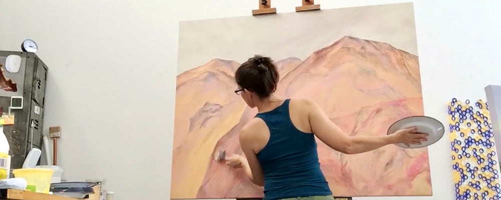 
        <div class='title'>
          Kate painting large mountain
        </div>
       
