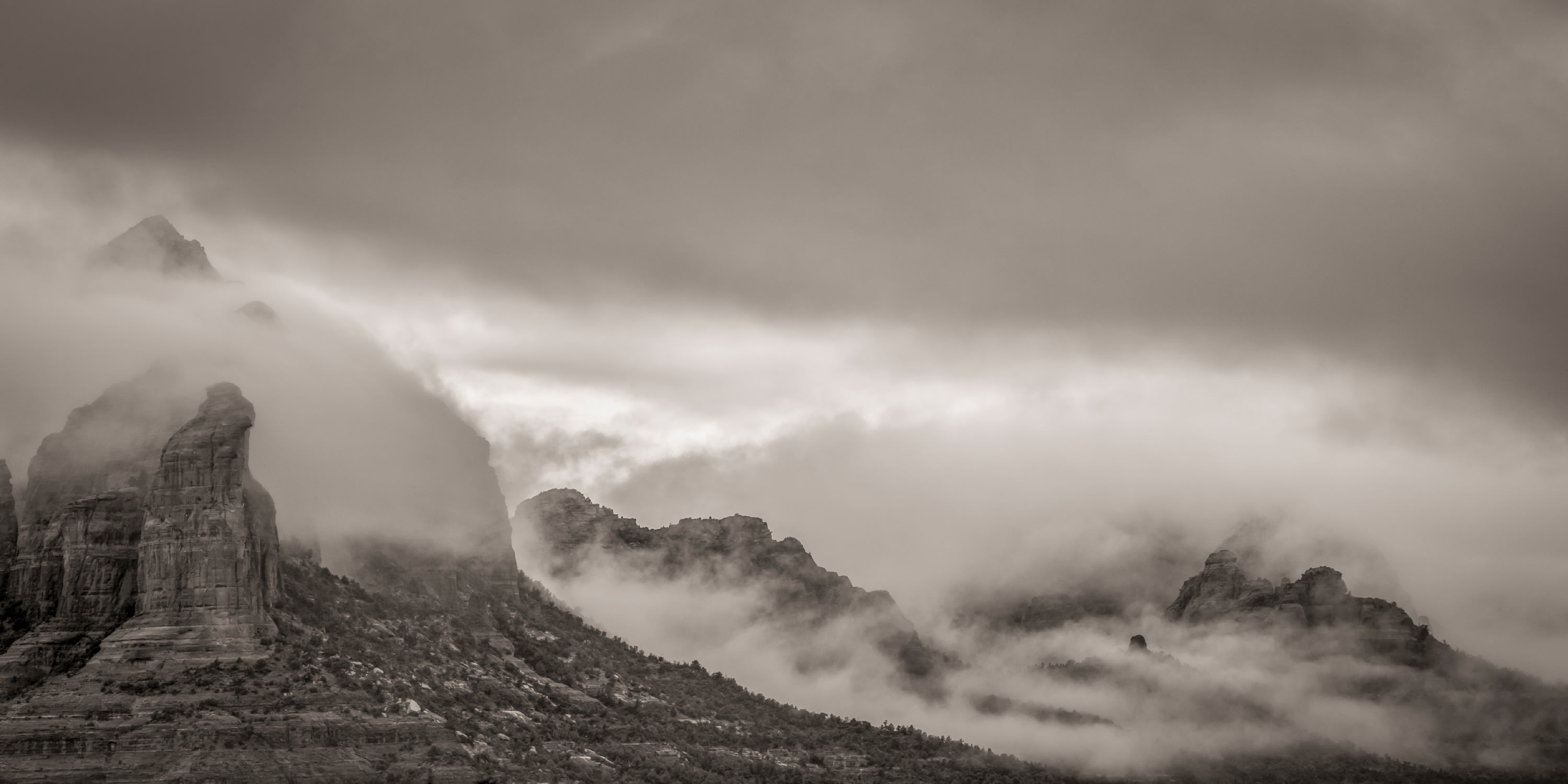 
        <div class='title'>
          Misty Morning, Sedona a panoramic wall art piece of low clouds covering mountains in Sedona, Arizona in black and white.
        </div>
       
        <div class='description'>
          
        </div>
      