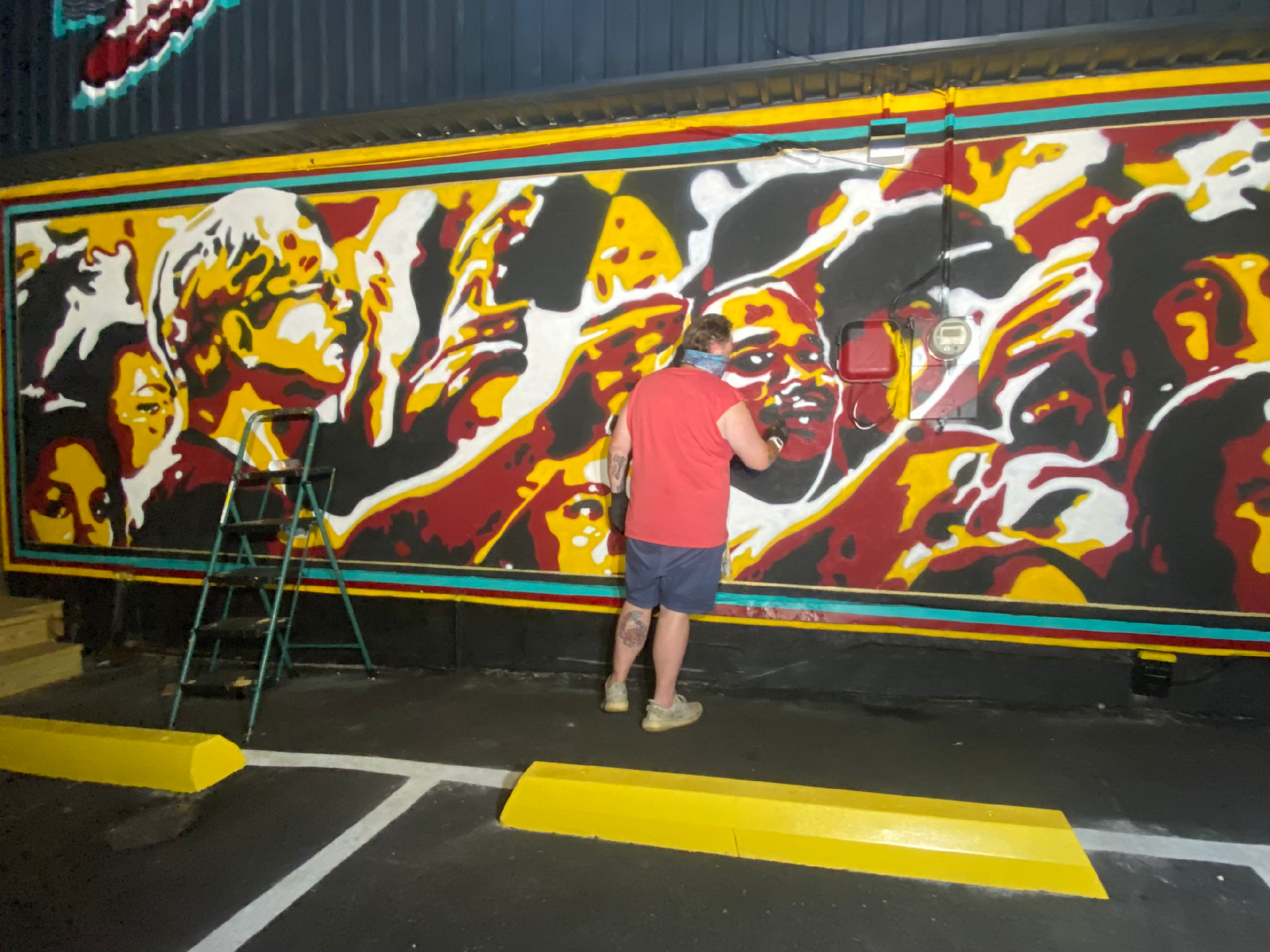 
        <div class='title'>
          briteso paints a Seminoles mural at the Garnet and Gold Store
        </div>
       
        <div class='description'>
          an artist paints on a wall using garnet, gold, black and white
        </div>
      