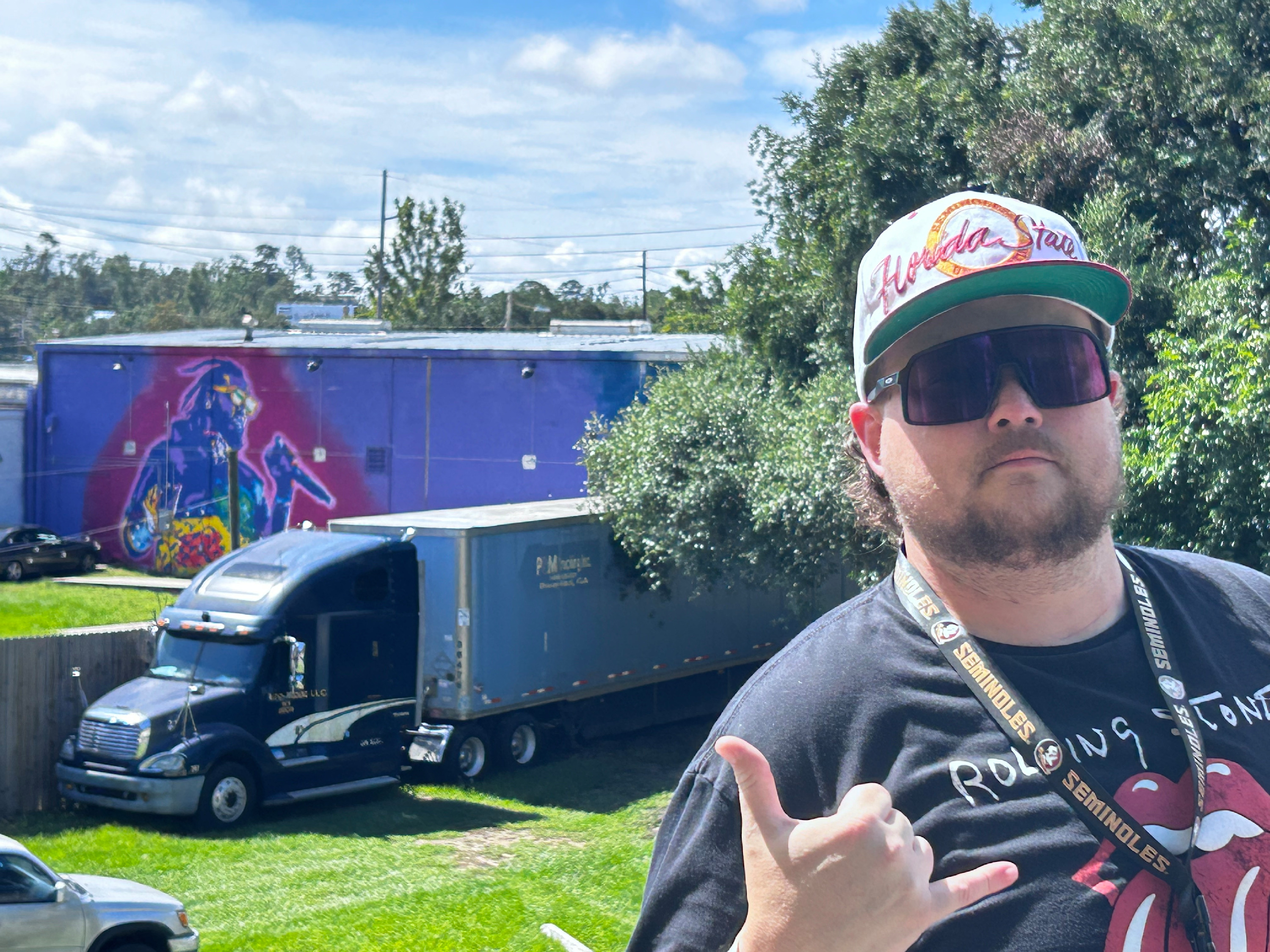 
        <div class='title'>
          The artist, briteso stands in front of his T Pain mural, "Tallahassee Love"
        </div>
       
        <div class='description'>
          An image of artist, briteso in Tallahassee, FL
        </div>
      