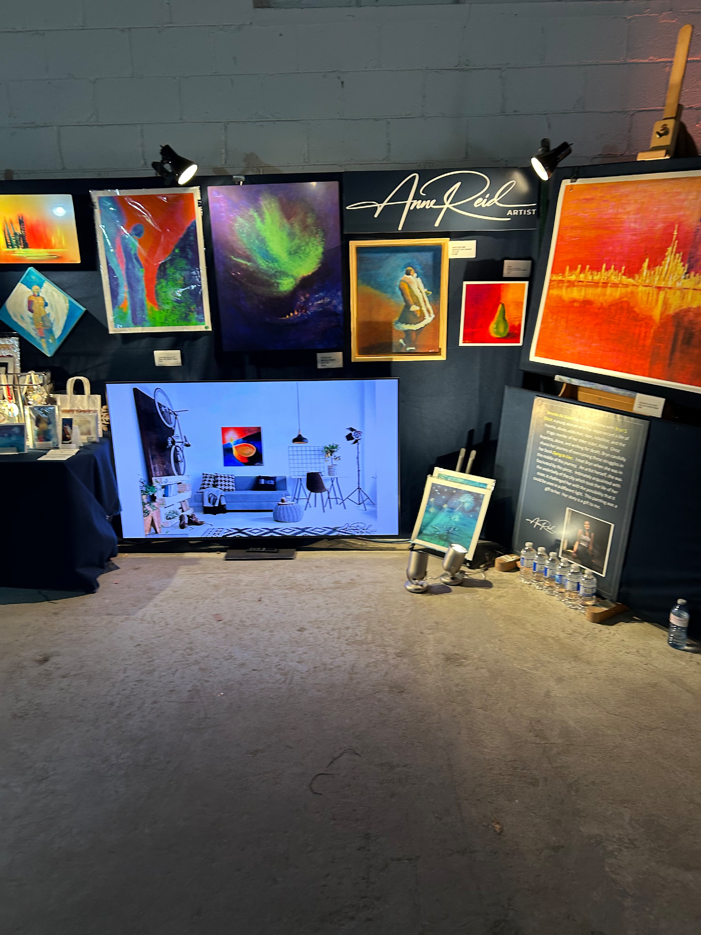Anne Reid Artist booth at RAW Toronto Artshow with logo and featured works
