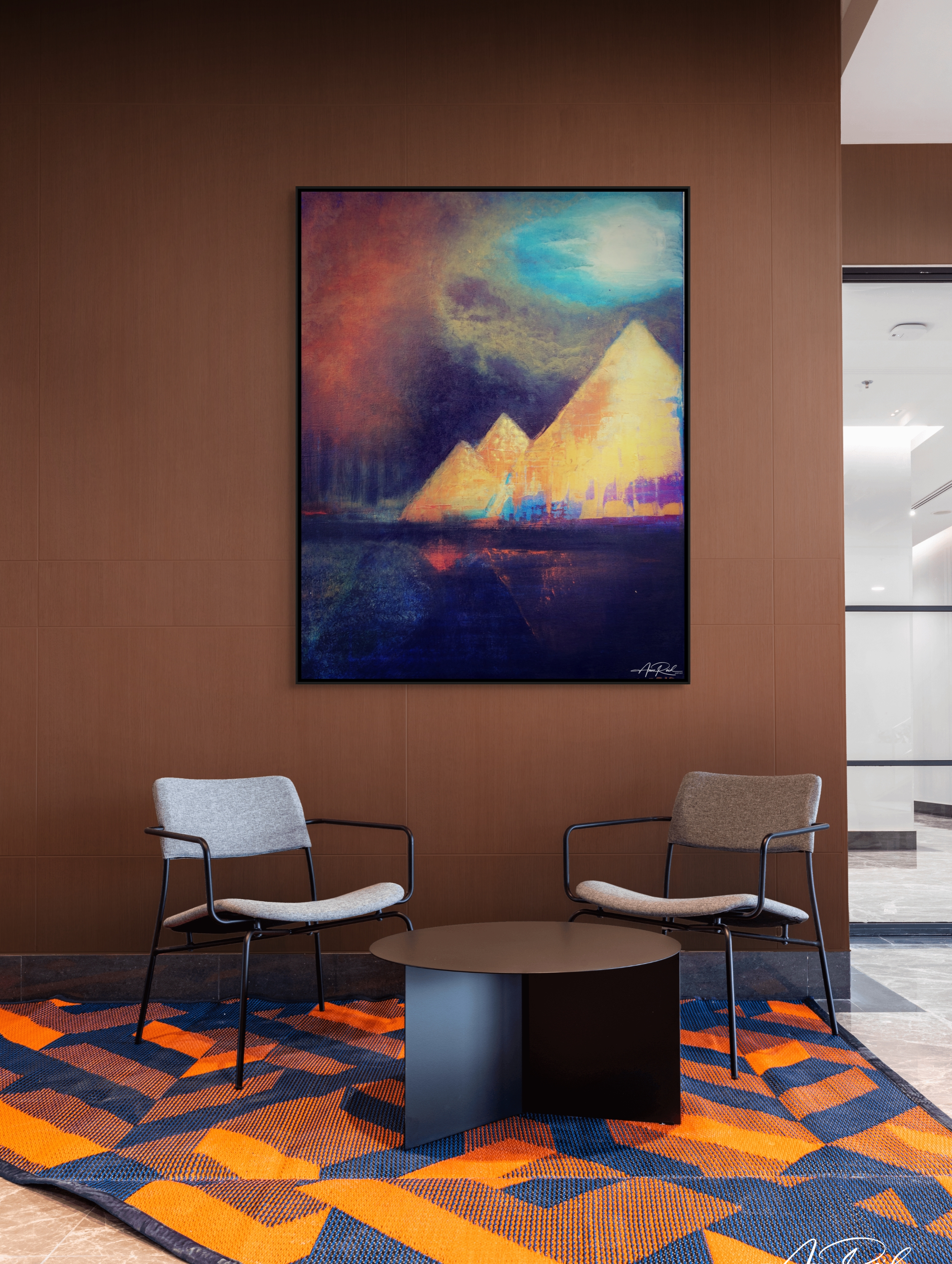 Egypt 2 open edition fine art print as a hospitality lobby statement—mocha wall, modern seating, and bold orange-blue rug