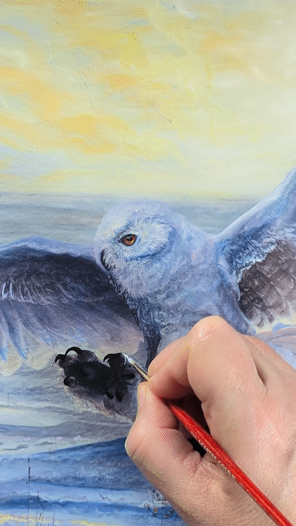 Allison Richter hand embellishing the Snowy Owl Artist Proof fine art print, painting acrylic details onto the talon area of the owl.