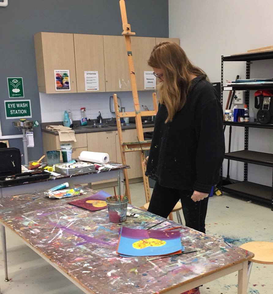 Anne Reid Artist standing at studio table shown at work during a prophetic painting session