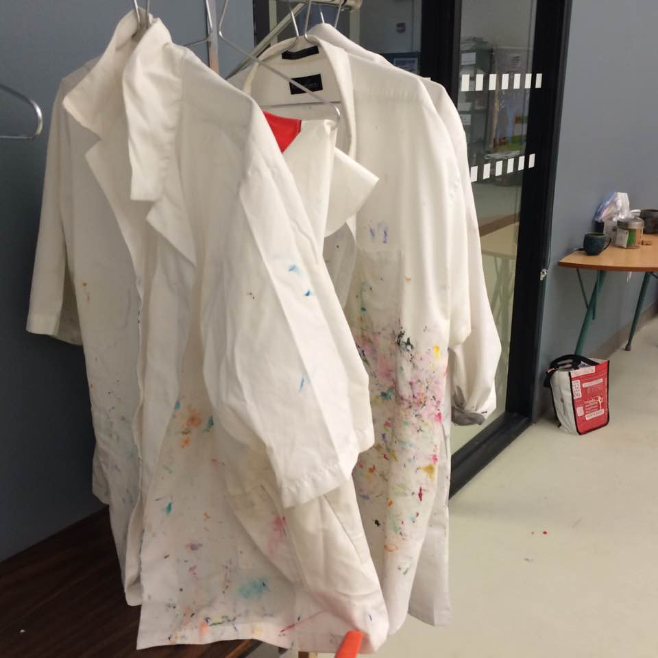 Paint-marked studio coats