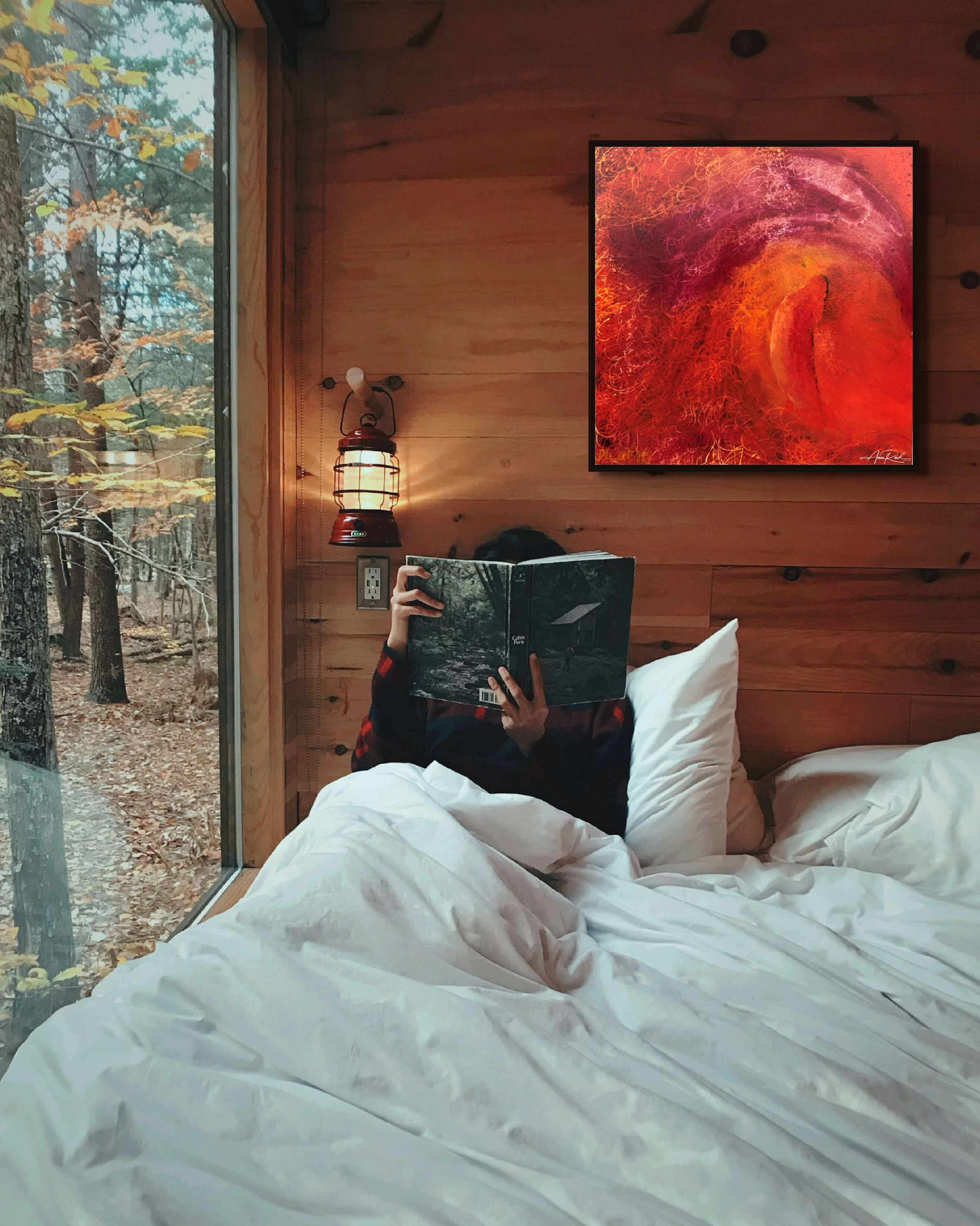 Jehovah Nissi by Anne Reid Artist shown in a rustic cabin reading nook setting